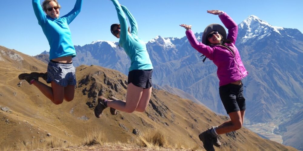 Ancascocha Trek + Inca Trail 7 DaysBeautiful photo and young ladies jumping in front of a snowy mountain in the Ancascocha trail 7 days