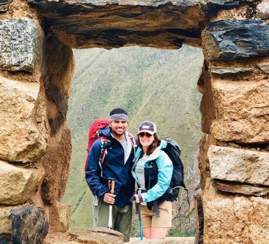 beautiful photo in the inca window of a happy couple on the ancascocha trail 7 days