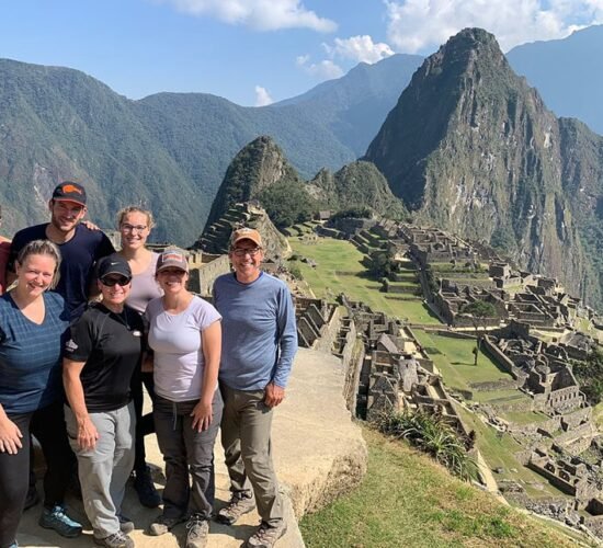 Group of family very happy when arriving at Machu Picchu