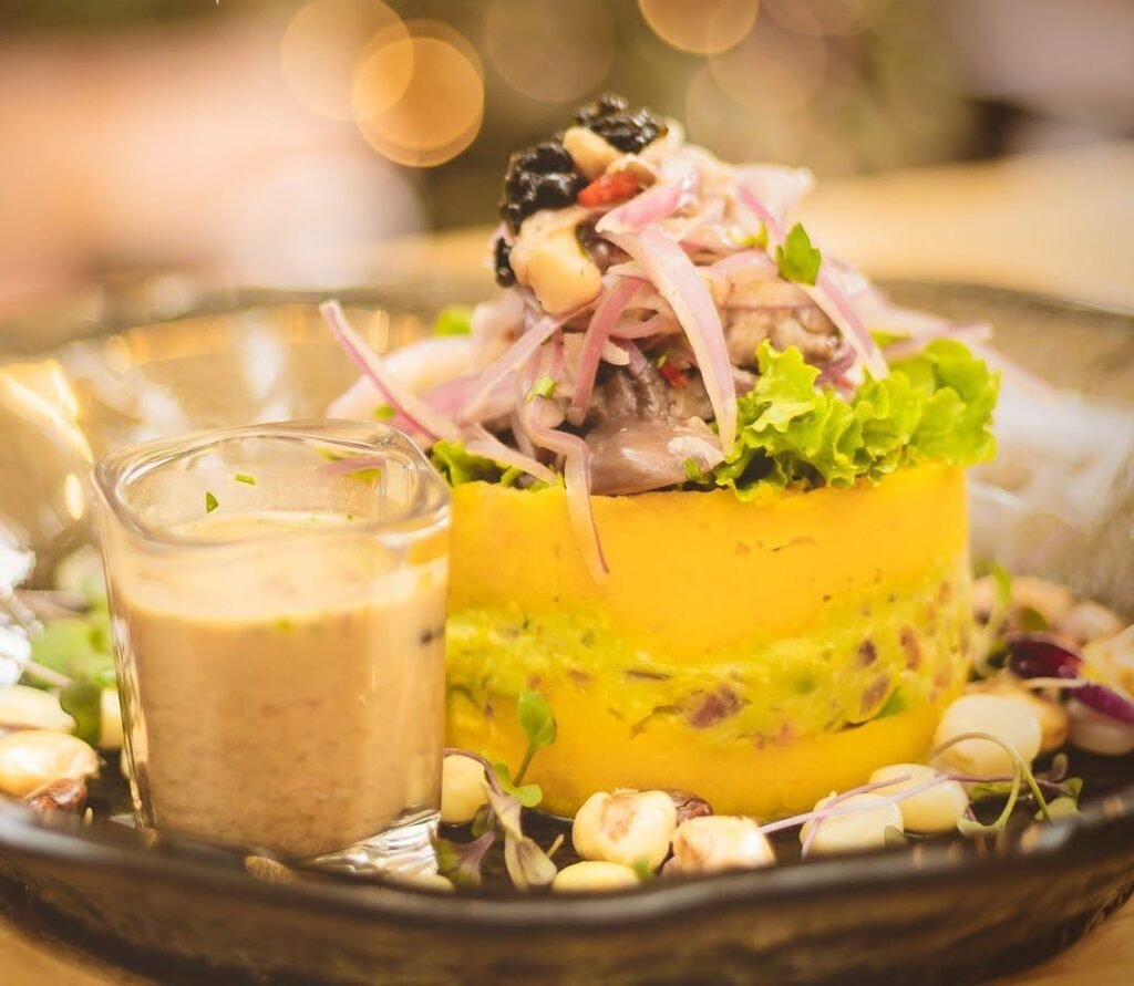 Ceviche with Causa accompanied with tiger's milk.